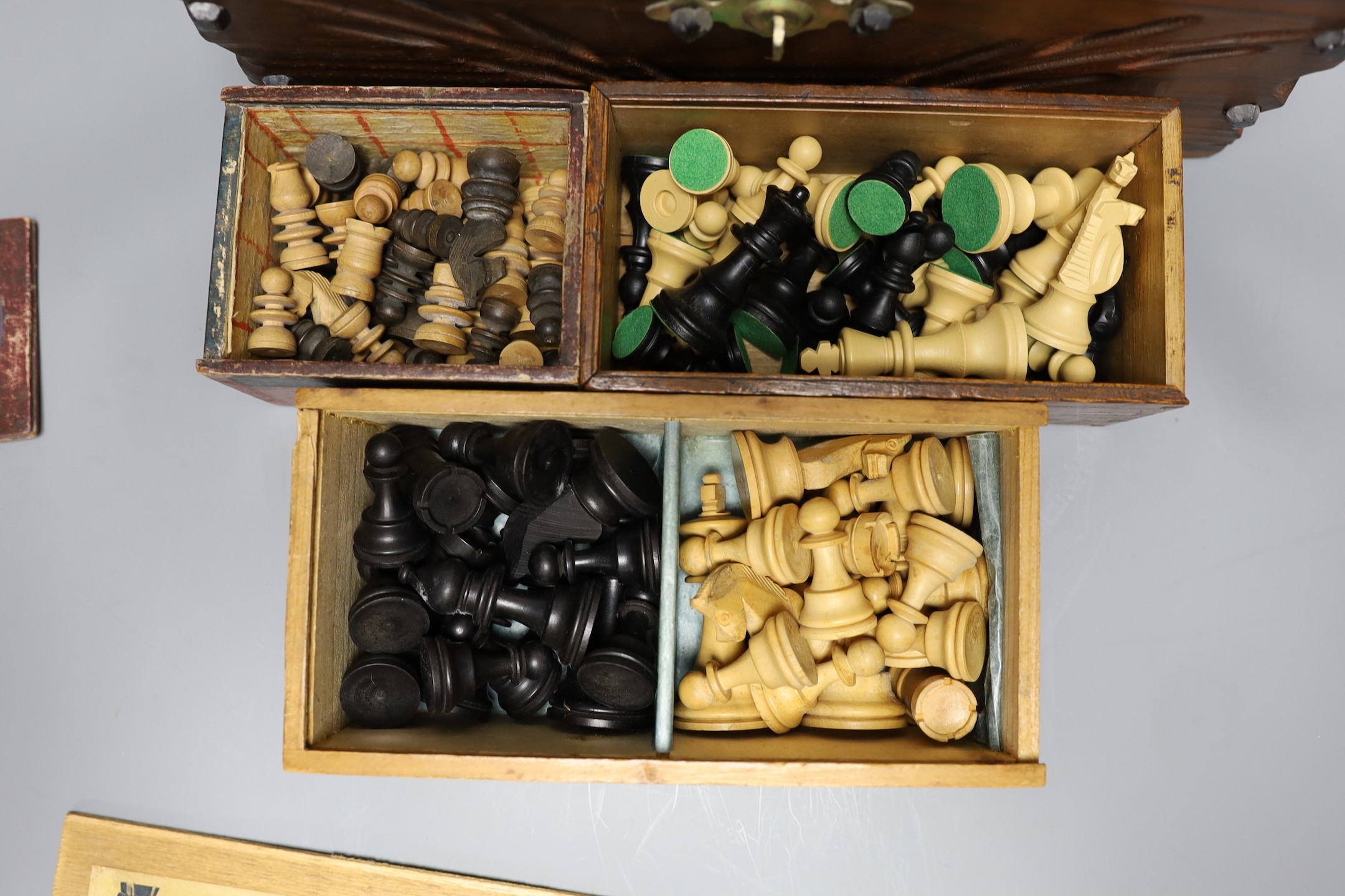 A Chinese carved wood chess set in carved mahogany box, together with three others and a dominoes set